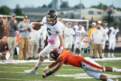 Joliet Catholic's Aidan Voss avoids a tackle from Brother Rice's Rolando Sepulveda, in Chicago, Friday, Oct. 8, 2021.  (Vincent D. Johnson / Daily Southtown).