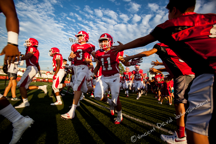 Hinsdale Central quarterback Josh Bean (3) and linbacker Brian McCarty (11), run onto the field through a tunnel of local youth football players, Friday, August 26, 2016, in Hinsdale. (Vincent D. Johnson-Pioneer Press).