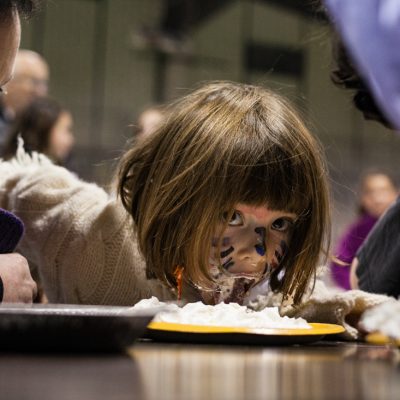 Oak Park, 10/26/12--Loretta Rosenthal, 5, of Oak Park, checks out the competition mid action and dad Sam, (left) coaches her on during the pumpkin pie-eating contest at the Hruby Ice Arena. | Vincent D. Johnson~for Sun Times Media