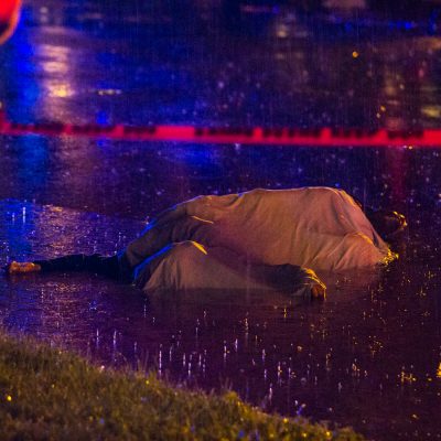 Chicago, 6/30/14--A 17 year old boy was shot and killed in the street on the 600 block of east 50th place Sunday night during the height of the storm. He clung to the last bit of life partially submerged in the gutter of the flooded one way street. | Vincent D. Johnson