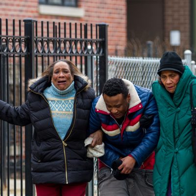 Possible friends or family members of grieve on a sidewalk in the 600 east block of 50th street after learning who the victims of a Valentines Day double murder were, February 14th, 2016, Photo by Vincent David Johnson.