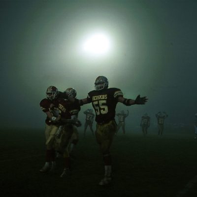 Morris High School football players celebrate after the final seconds of their state playoff semi-final victory of Metamora. A change in the weather brought about a thick fog starting at halftime making it difficult to see the even the other sideline. Photo by Vincent D. Johnson/for IHSFW.com Nov., 2001.