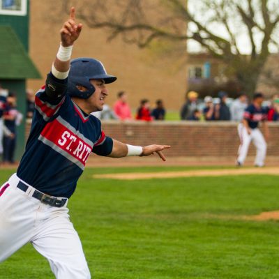 St. Rita's Esteban Martinez, starts to celebrate as his hit drove in the game-winning run in the bottom of the 7th inning to beat Providence, Wednesday April 29, 2015 in Chicago.  (Vincent D. Johnson/For the Southtown Star).
